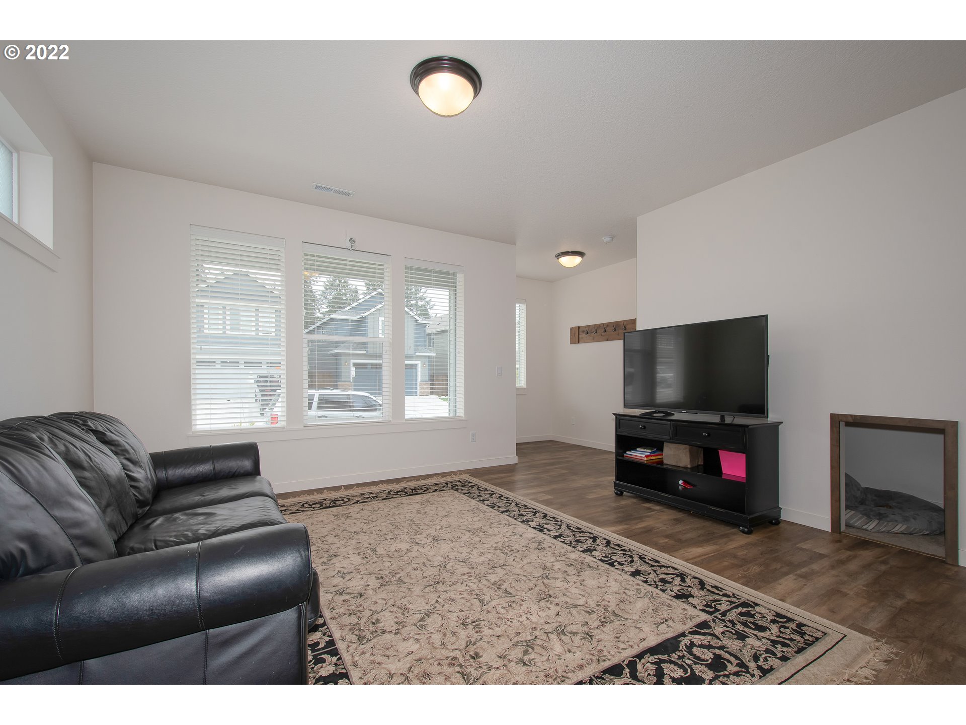 7030 South Ridge Way Ridgefield, WA 98642 - Photo 7 of 27 a living room with furniture and a flat screen tv