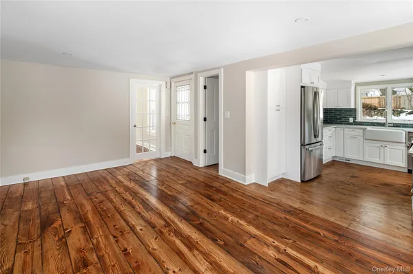a view of a room with wooden floor and windows