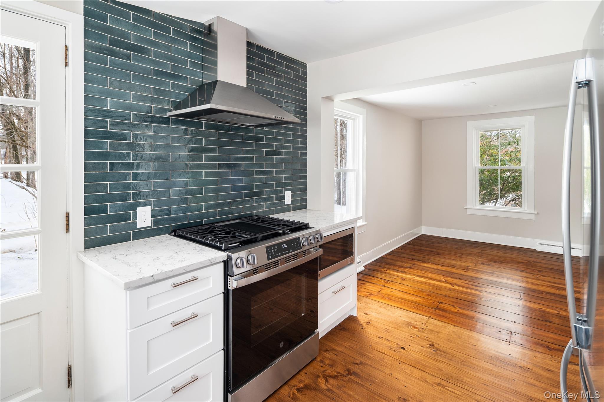 277 Old Post Road Bedford, NY 10506 - Photo 18 of 39 a kitchen that has a stove and a wooden floor