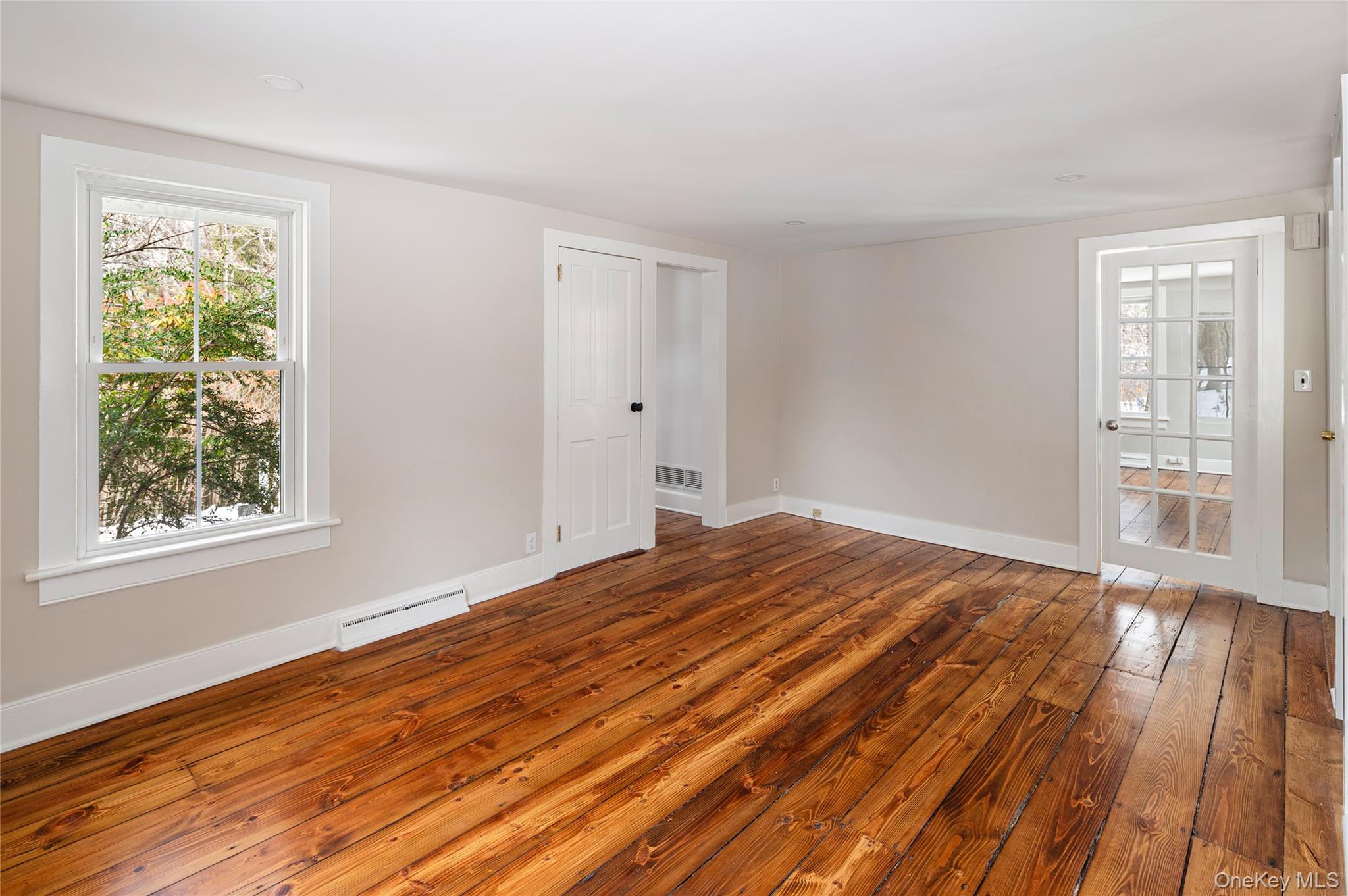 277 Old Post Road Bedford, NY 10506 - Photo 19 of 39 a view of a bedroom with wooden floor and windows