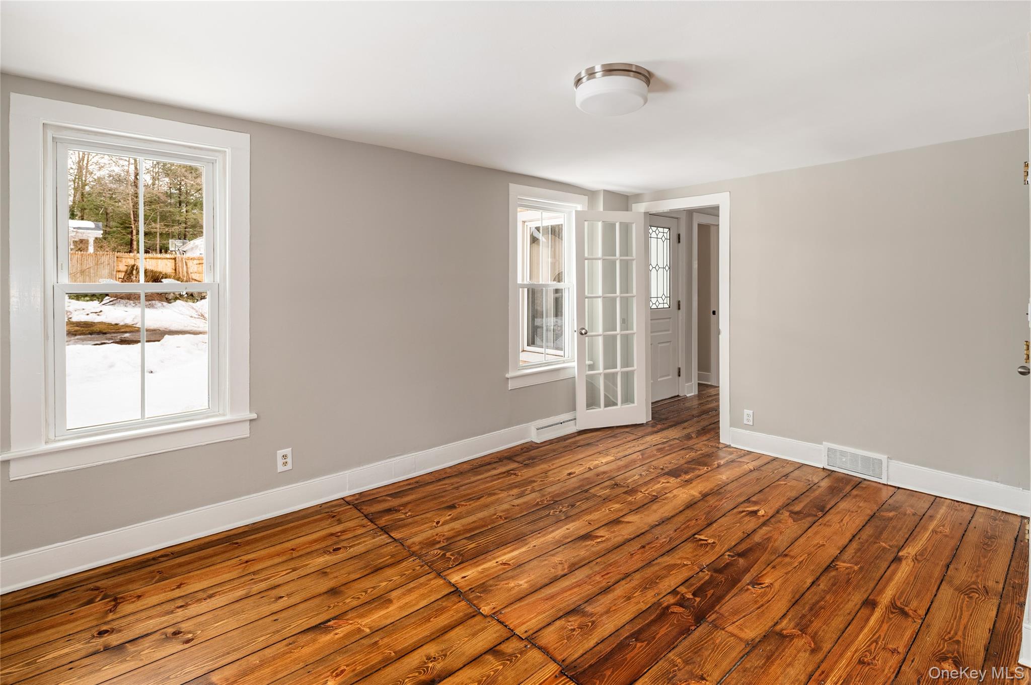 277 Old Post Road Bedford, NY 10506 - Photo 25 of 39 a view of an empty room with wooden floor and a window