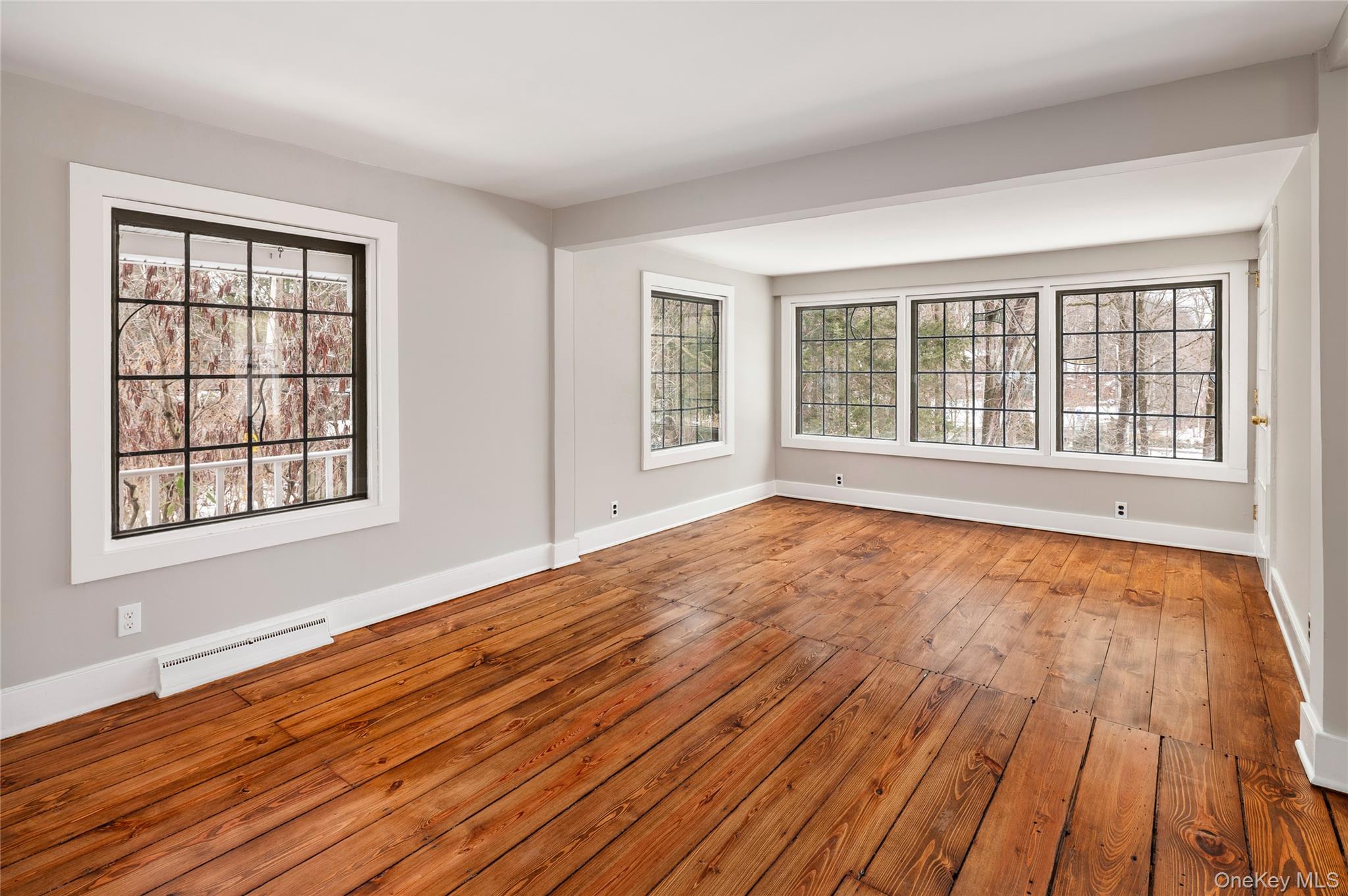 277 Old Post Road Bedford, NY 10506 - Photo 28 of 39 a view of an empty room with wooden floor and a window