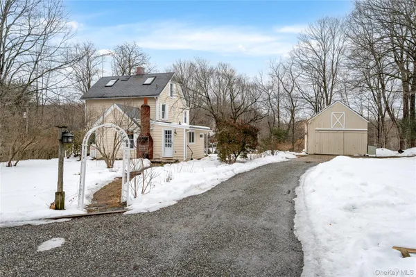 a front view of a house with a yard covered in snow