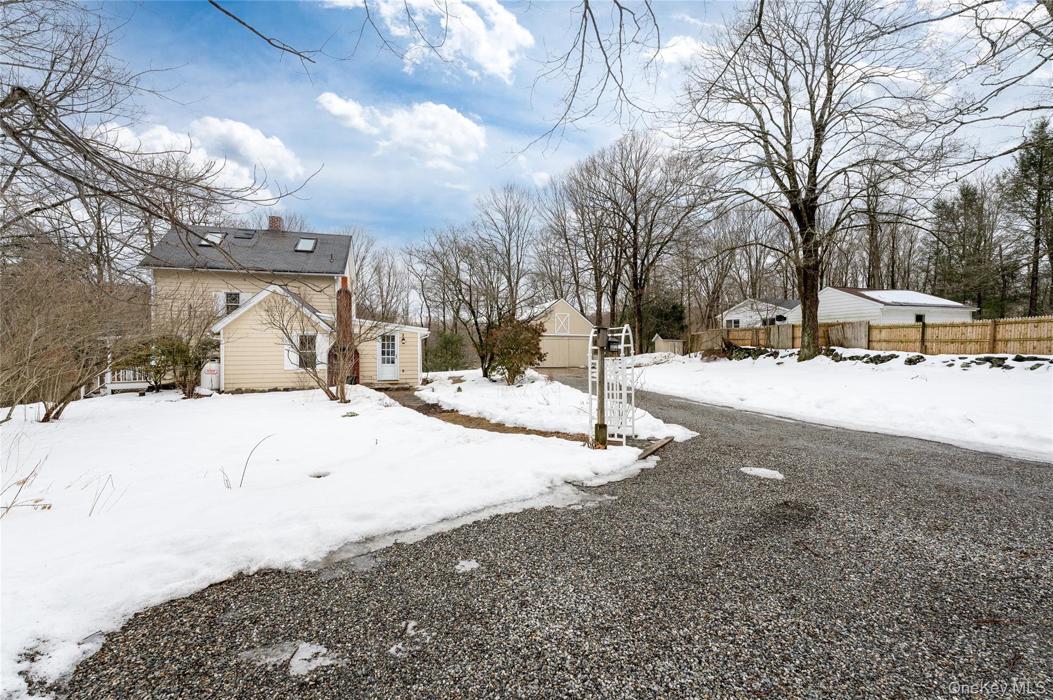 277 Old Post Road Bedford, NY 10506 - Photo 7 of 39 a street view covered with snow