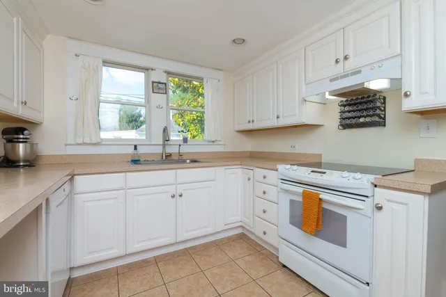 a bedroom with a large bed and a tv on a dresser