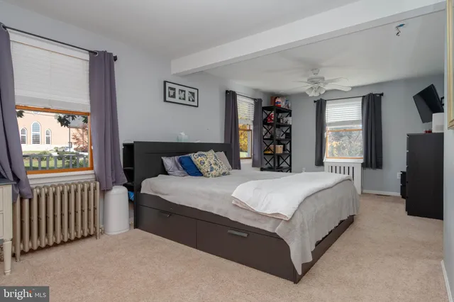 a bedroom with furniture and a window