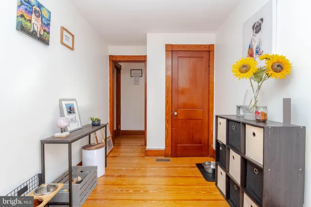 a living room with furniture a rug and a book shelf