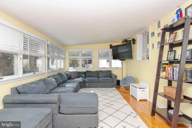 a living room with lots of furniture and a baby crib