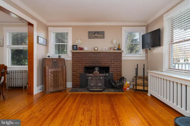 a view of entryway livingroom and hall with wooden floor