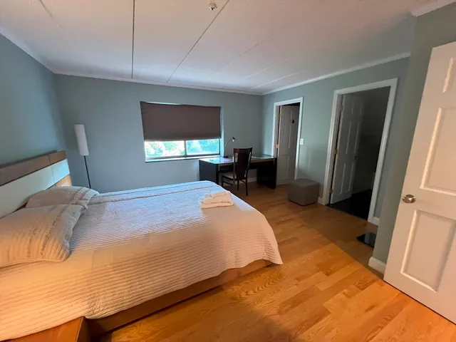 a bed sitting in a bedroom next to a window