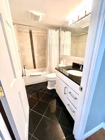 a bathroom with a sink a vanity and a bathtub