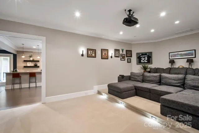 a living room with furniture and a ceiling fan