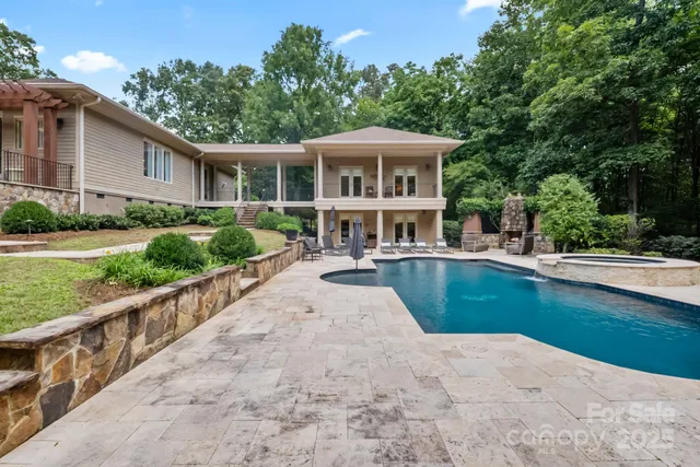 a view of house with outdoor space and swimming pool