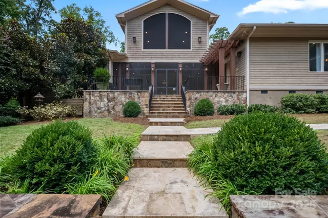 a front view of a house with a garden