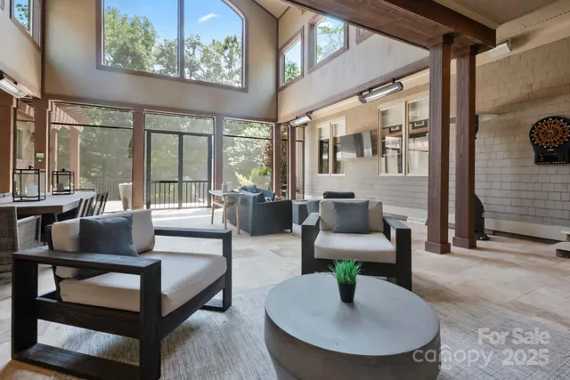 a living room with furniture and a floor to ceiling window