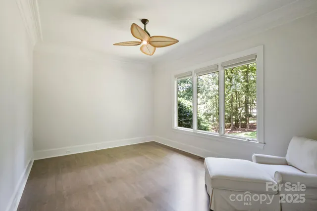 a view of a livingroom with a window and a ceiling fan