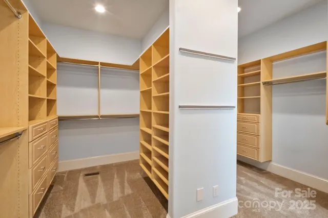 a view of walk in closet with empty racks
