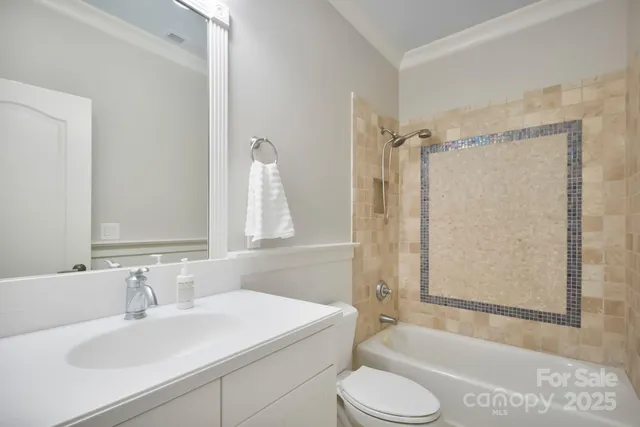 a bathroom with a sink toilet tub and shower