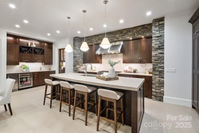 a kitchen with stainless steel appliances kitchen island granite countertop a sink and cabinets