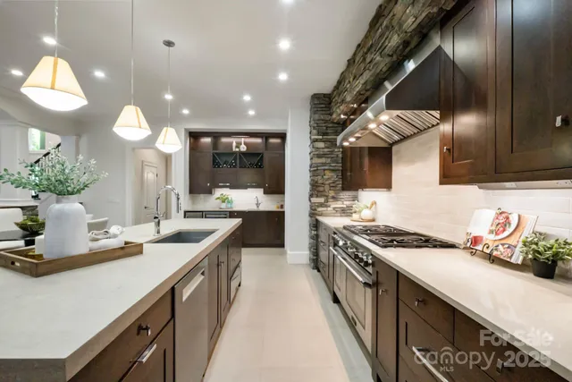 a kitchen with kitchen island a sink appliances and cabinets