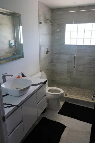 a bathroom with a sink toilet and shower