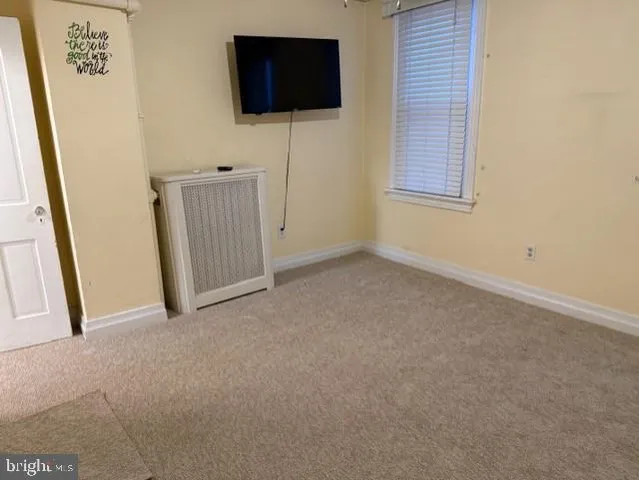 a view of an empty room with a flat screen tv