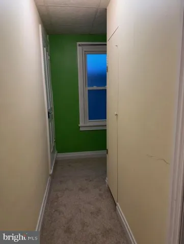 a view of a hallway with brick walls