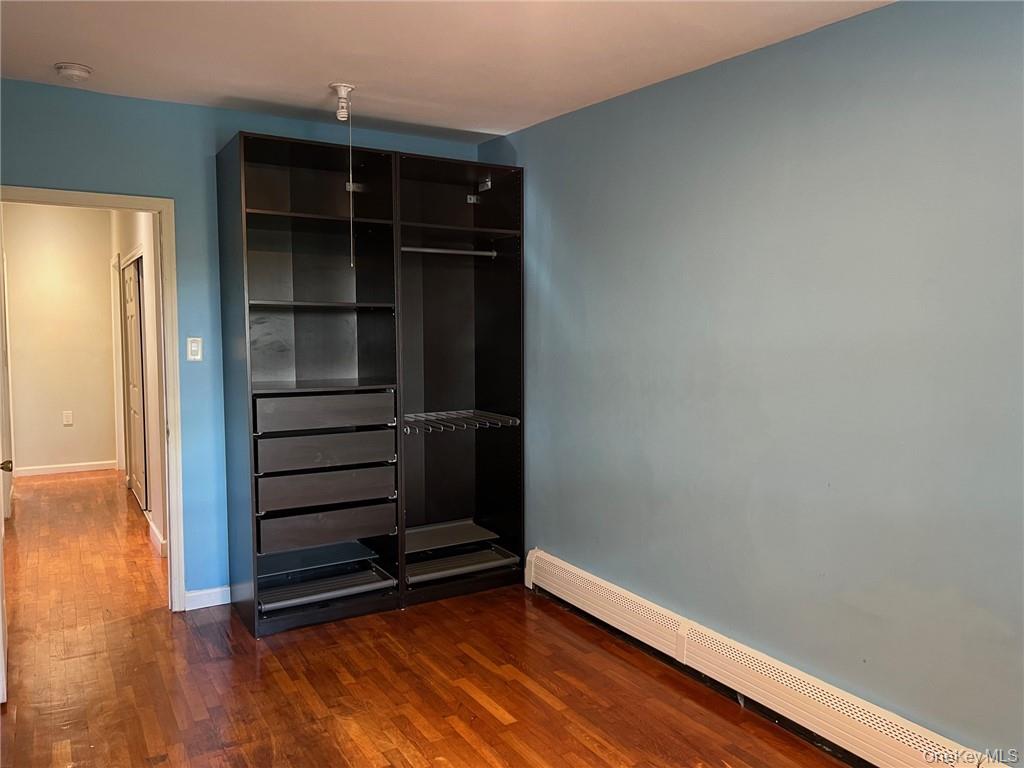 708 Silver Lake-Scotchtown Road Middletown, NY 10941 - Photo 15 of 25 Unfurnished bedroom featuring a baseboard heating unit and dark hardwood / wood-style flooring