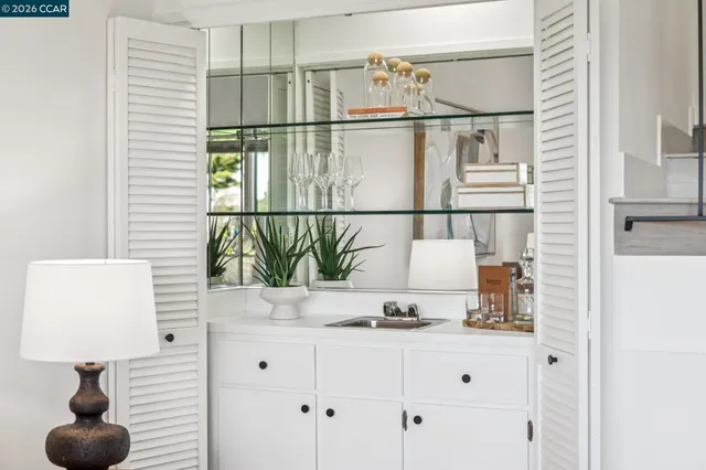 a dining room with furniture a chandelier and wooden floor