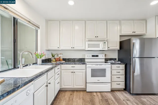 a view of a kitchen with kitchen island table and chairs in it