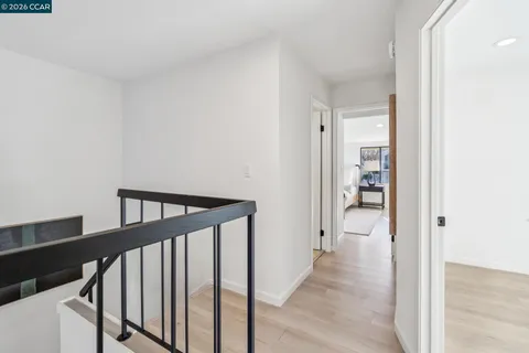 a large bedroom with a bed and large window
