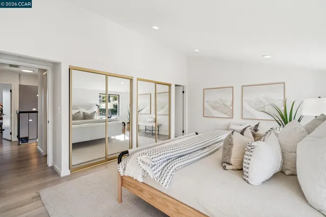 a bedroom with a large bed and a chandelier