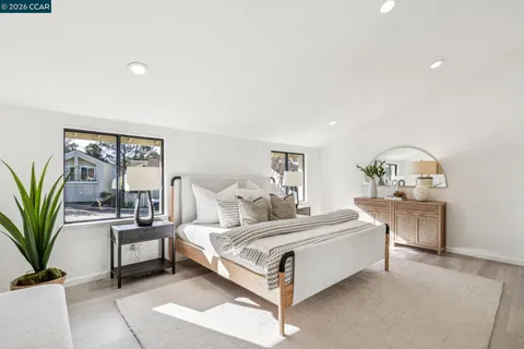 a bedroom with a bed and large window