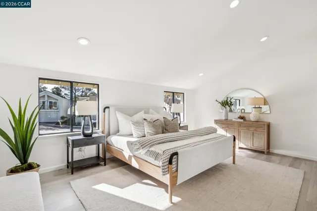 a bedroom with a bed and large window