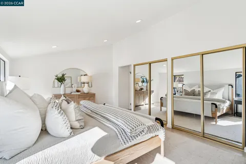 a bathroom with a granite countertop sink mirror vanity and toilet