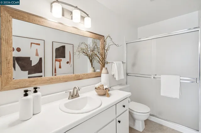 a bedroom with a large bed and a balcony