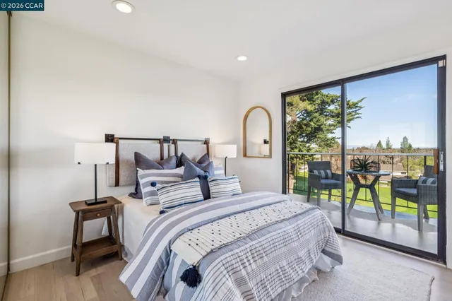 a bedroom with a bed and a large window