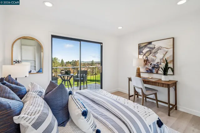 a bedroom with a bed a mirror and lamp