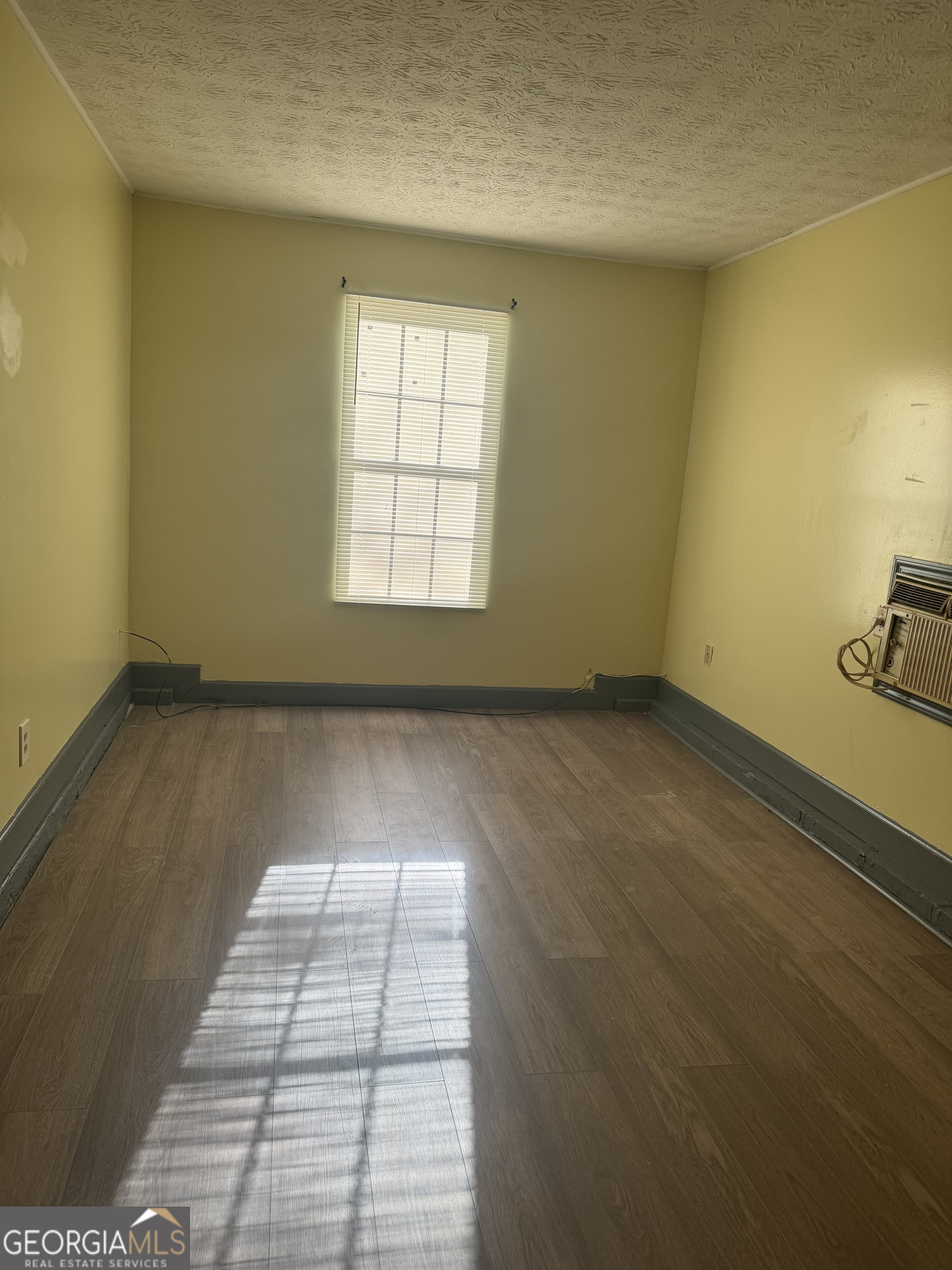 5666 Marbut Road Lithonia, GA 30058 - Photo 2 of 6 an empty room with windows