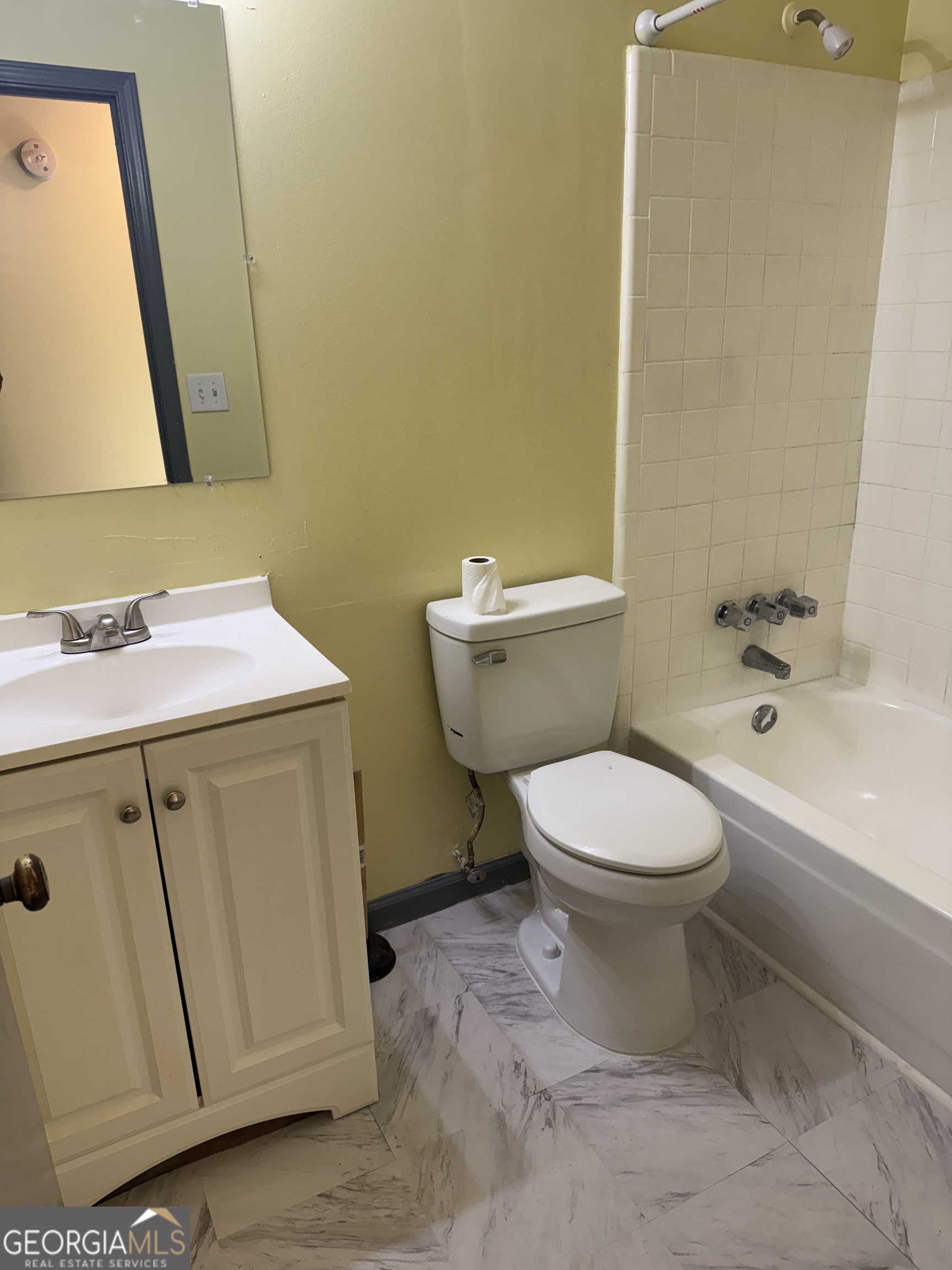 5666 Marbut Road Lithonia, GA 30058 - Photo 4 of 6 a bathroom with a granite countertop toilet a sink and a bathtub