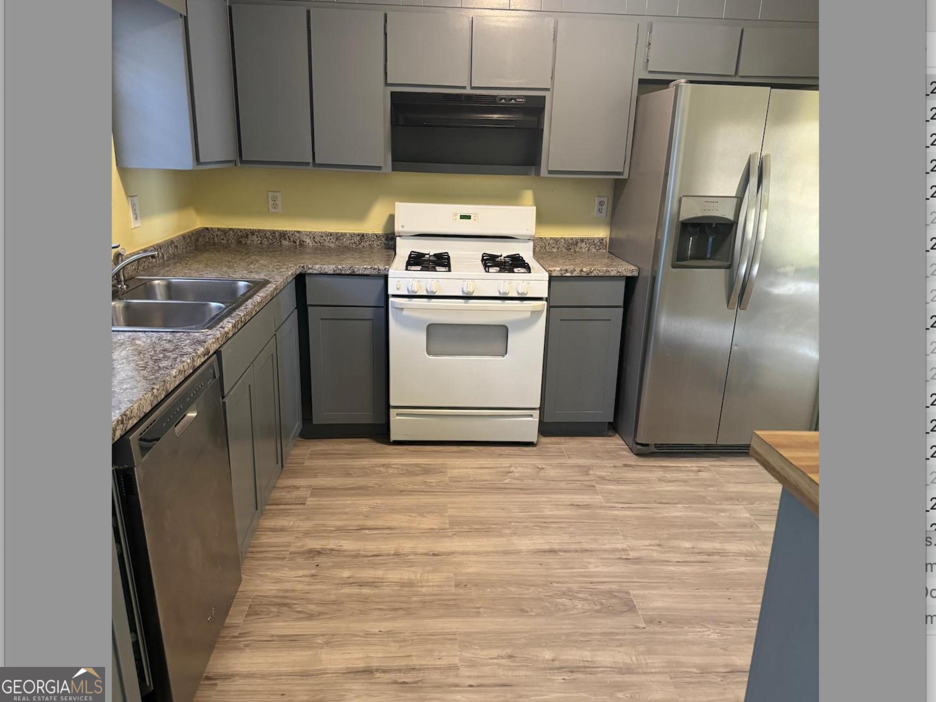 5666 Marbut Road Lithonia, GA 30058 - Photo 6 of 6 a kitchen with granite countertop a stove and a refrigerator