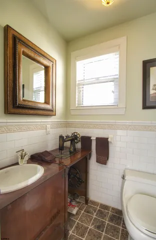 a bathroom with a sink a toilet and a window