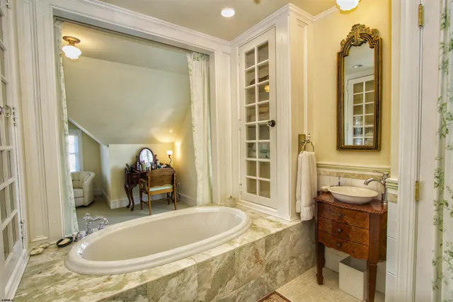 a bathroom with a tub and sink