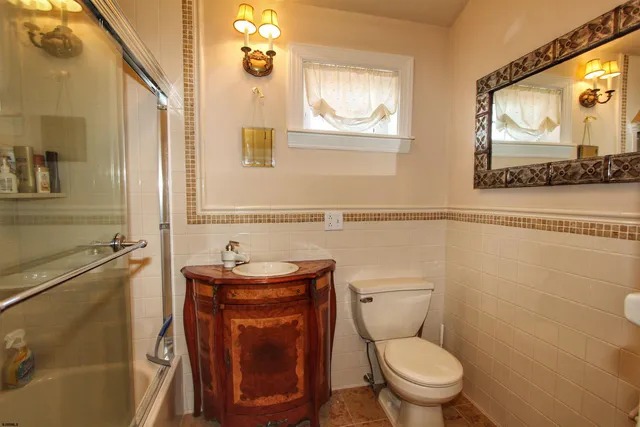 a bathroom with a toilet a sink and a mirror