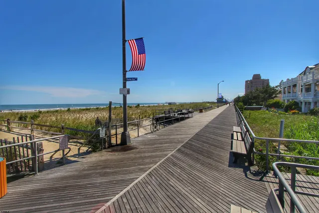 a view of a balcony with chairs and wooden floor