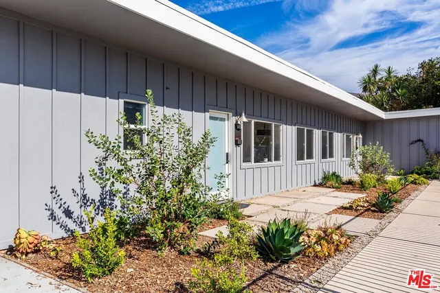 a front view of a house having fountain