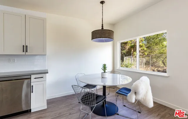 a view of a dining room with furniture window and wooden floor