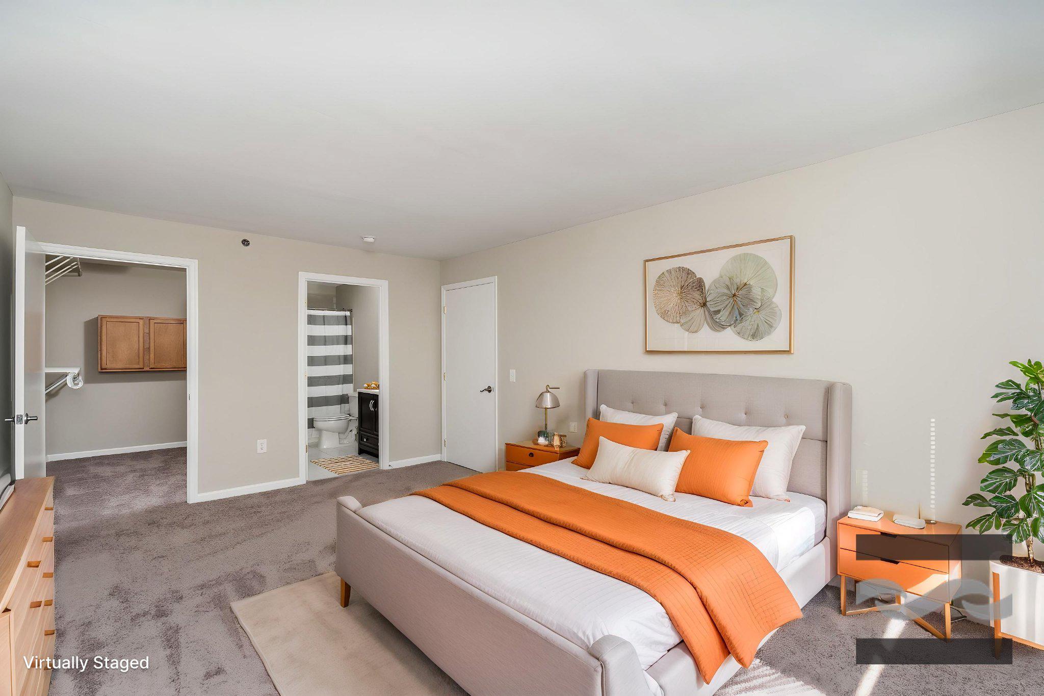 2702 Lighthouse Point East, Unit 532 Baltimore, MD 21224 - Photo 3 of 44 a bedroom with a large bed and a couch