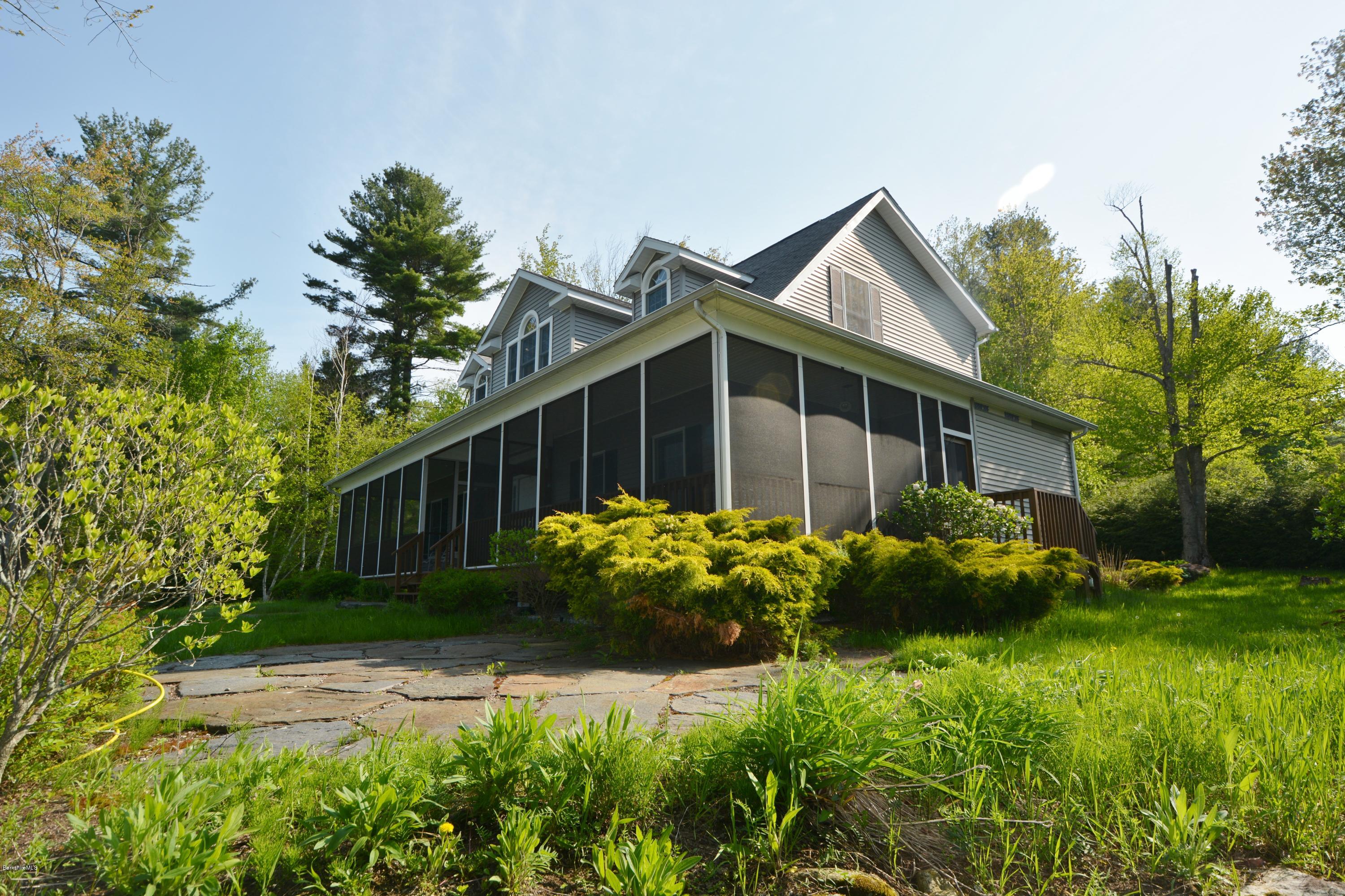 54 Ona Road Tolland, MA 01034 - Photo 3 of 5 a front view of house with backyard and green space