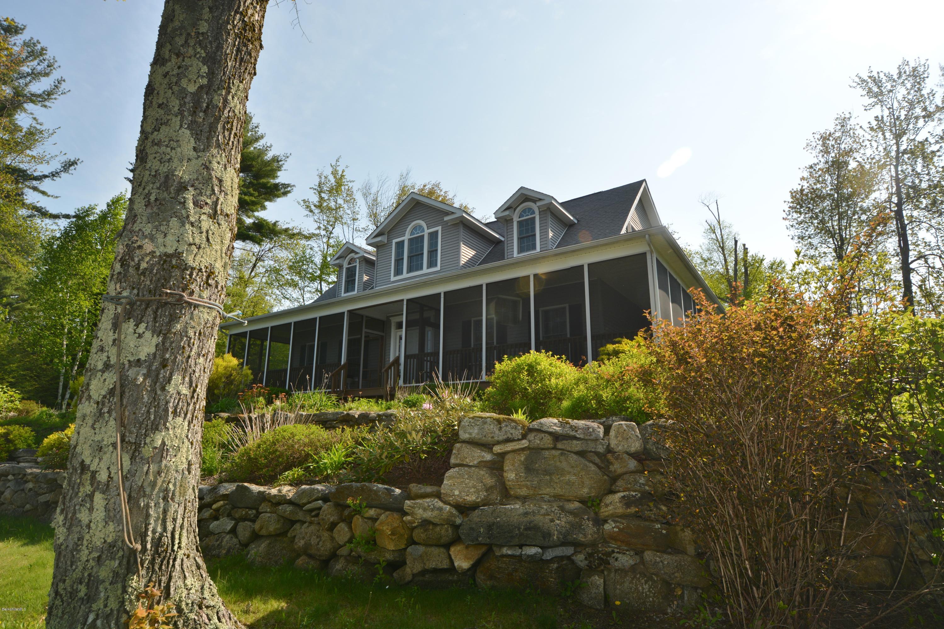 54 Ona Road Tolland, MA 01034 - Photo 4 of 5 a front view of house with yard and trees in the background